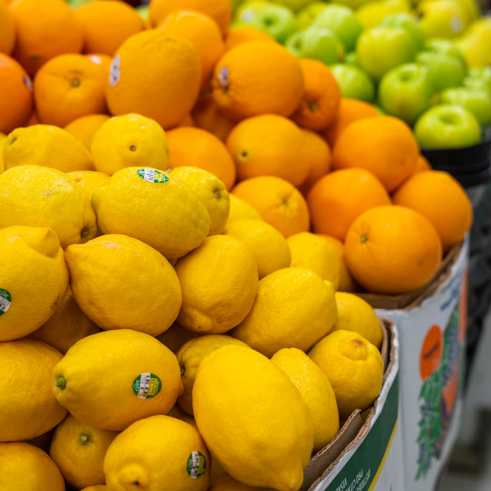Lemons, oranges, and green apples piled high in the produce section